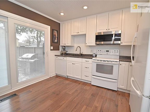 Remodeled kitchen with hardwoods and blinds-in-glass slider