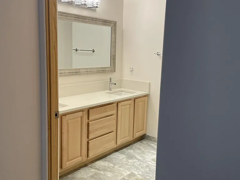 Upstairs bathroom at 3202 "The Edward" loft has double sinks.
