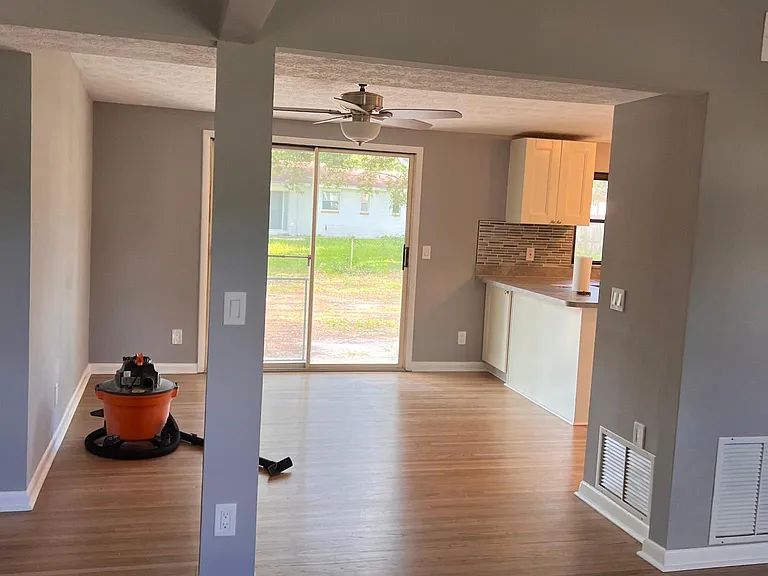 View from the living room to the dining room and sliding glass door to the backyard.
