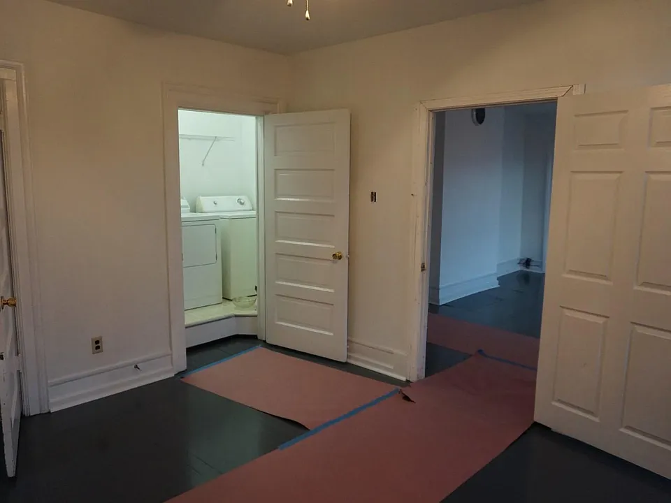 Third Bedroom with Laundry Room looking into the Living Room