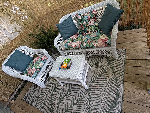 Cozy patio at the top of the stairs, immediately outside apartment door.