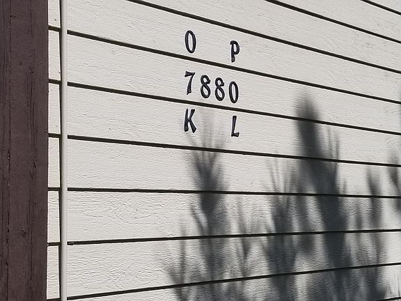 Building exterior - building number surrounded by unit lettering