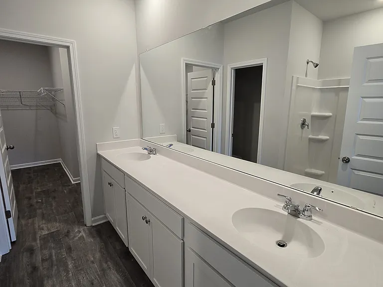 Ensuite for primary bedroom, dual sinks, shower and spacious walk in closet