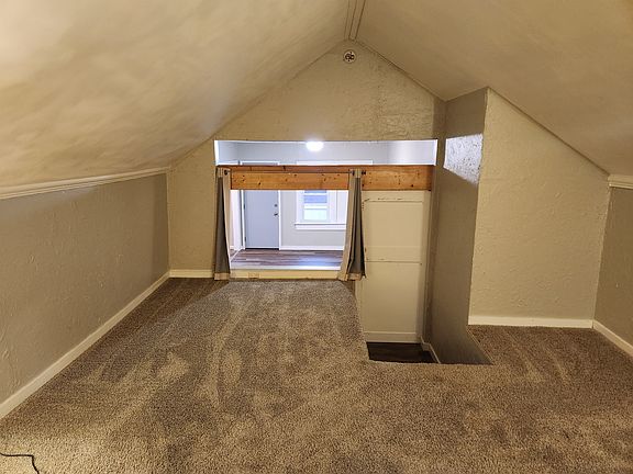 Loft bedroom with curtains open.