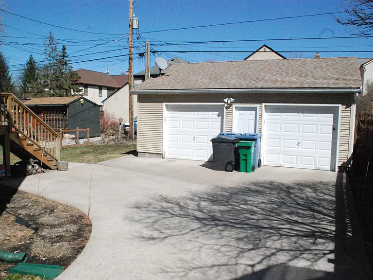 Large parking pad has plenty of room for owner to make 3 point turn in his full size (16' long) and back into south garage. This permits avoidance of backing out down driveway!