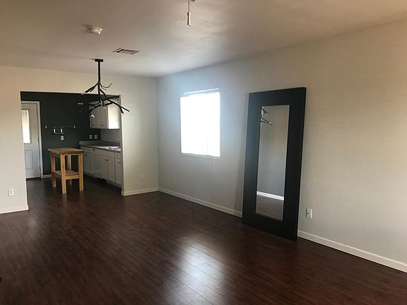 Living room opens into dining room and kitchen.