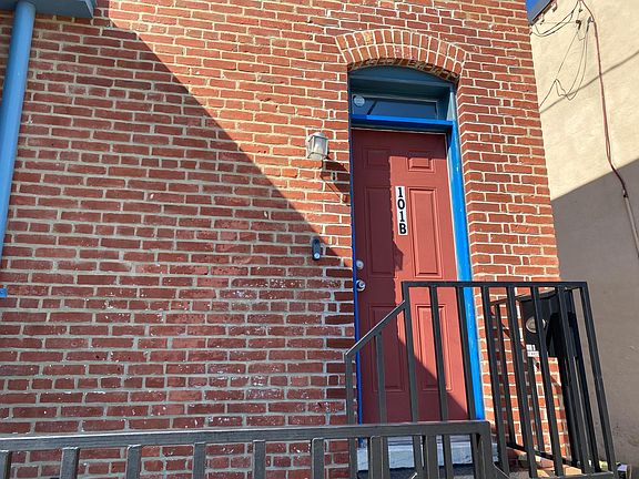 Entrance door and porch area at the end of the alley.