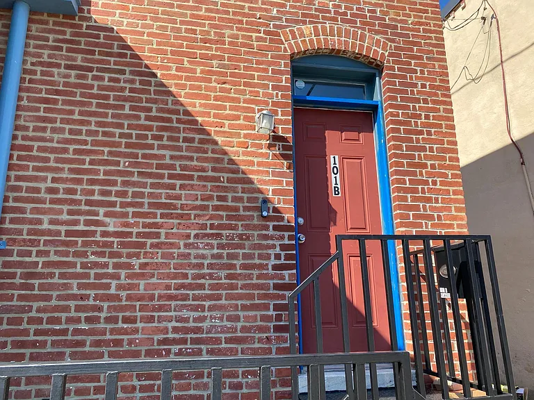 Entrance door and porch area at the end of the alley.