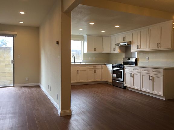 Remodeled kitchen with high-end cabinets and vinyl wood flooring and recessed lights