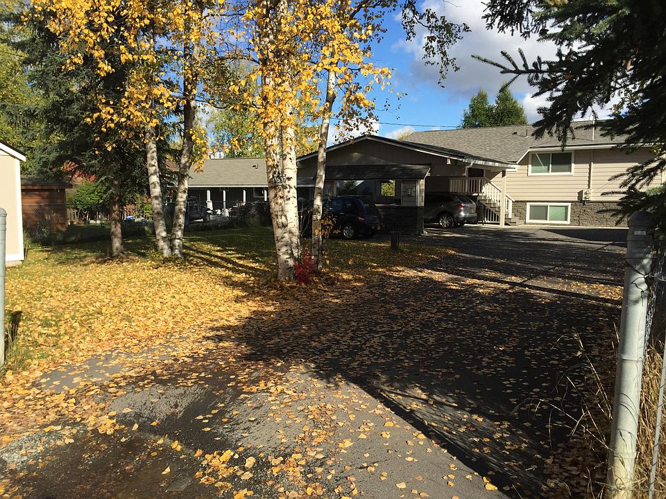 Driveway and front of house. Includes two parking spots - one in carport and one next to carport.