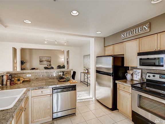 Kitchen features an open floor plan to the main living area. Stainless steel appliances stay with unit. 