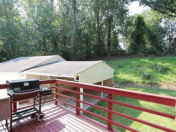 Back yard, showing gas-powered BBQ and covered outdoor deck