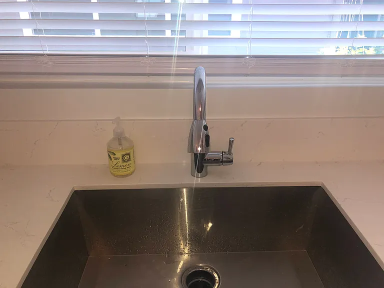 Charming kitchen with farm stainless sink and white cabinets