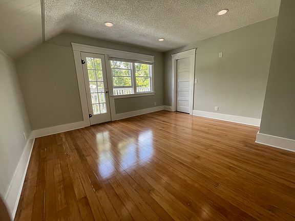 North Bedroom with Closet Door, North Balcony is on other side of panel door and windows.