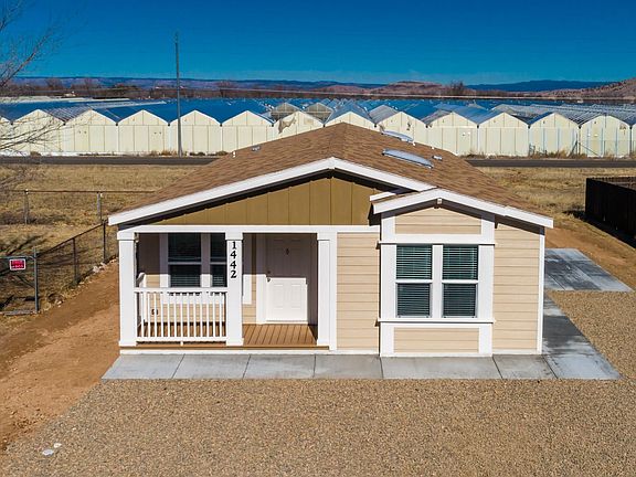 Nice covered deck, concrete walk around to large side patio!  Great for BBQ or hanging outside. 2x6 construction, upgraded insulation, Low-E vinyl windows.  Ground set with concrete block foundation.