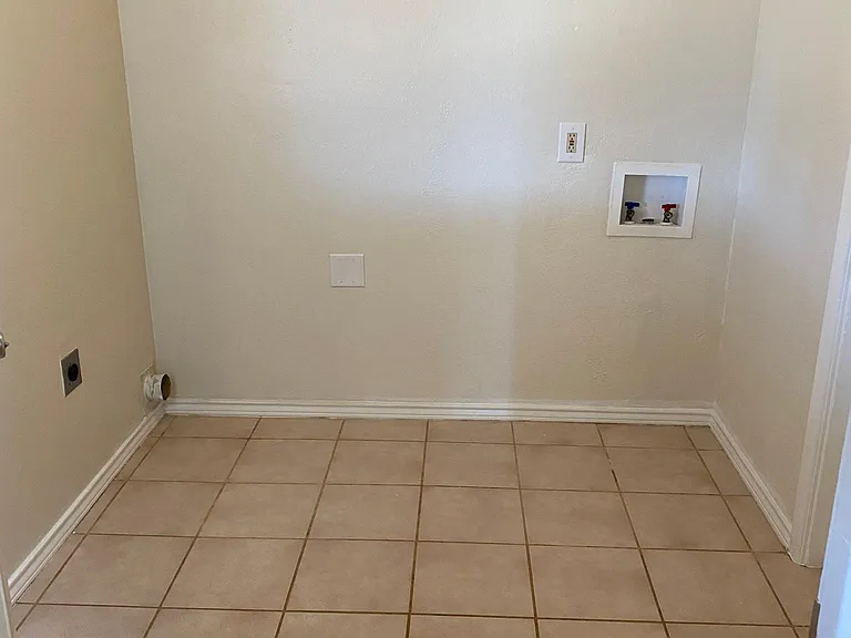 Laundry area. So convenient right off of the kitchen. There's a door so you don't have to see or hear your laundry going if you don't want to. :)