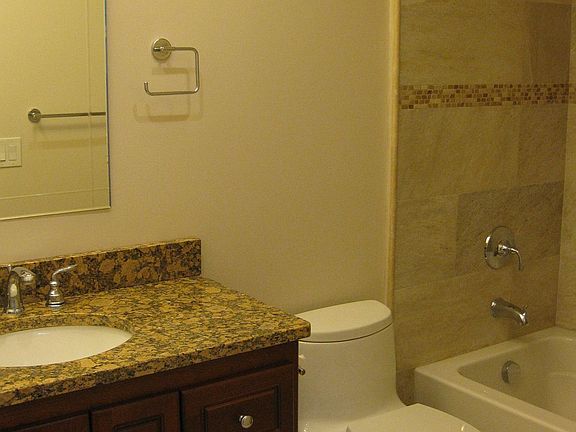 Bathroom with granite counter-tops, tile floor, bathtub/shower