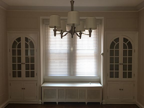 2 Built-In Cabinets flank a sunny window seat. A new chandel