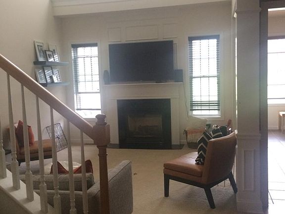 Bright, open living/family room with vaulted ceiling w/fan