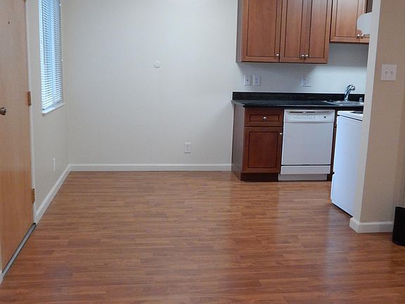 Eat-in kitchen with wood flooring