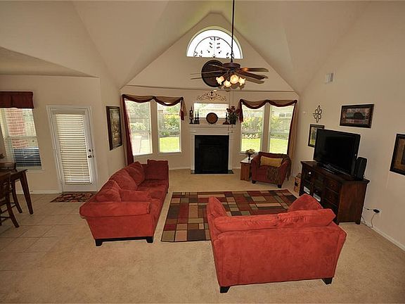 With a stunning cathedral ceiling and large windows, the living room offers that grand look.