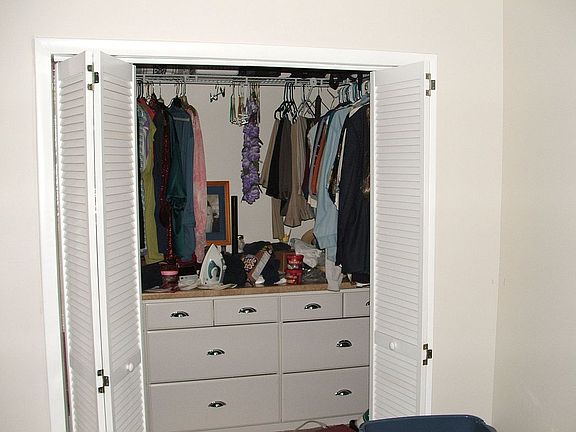 Master closet with built in cabinets