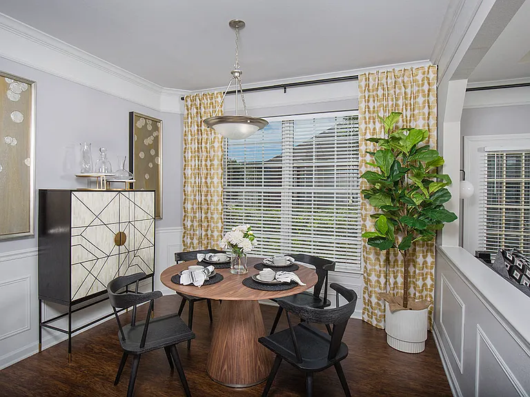 Dining area with crown molding and judges panels