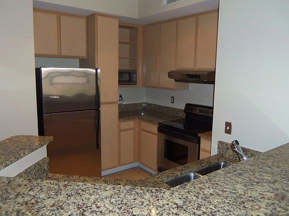 Kitchen features GE Profile stainless steel appliances.