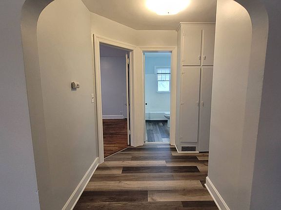 Hallway with built in storage and access to the back yard area