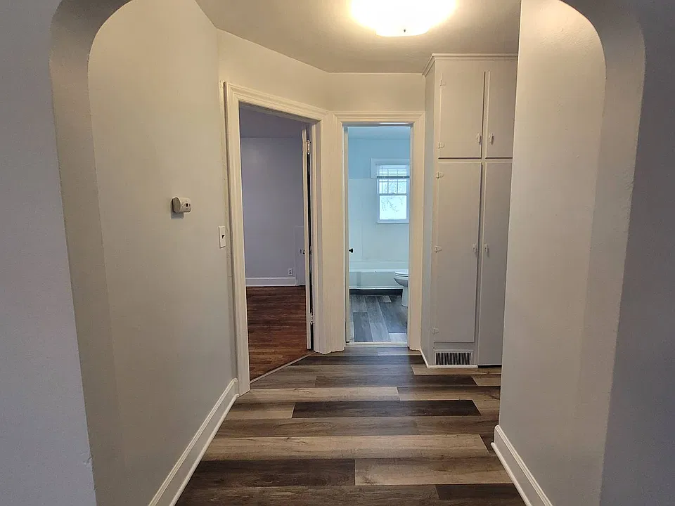 Hallway with built in storage and access to the back yard area