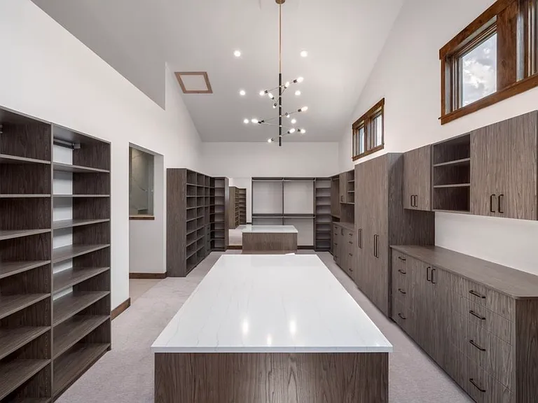 Custom Walk in Master Closet over 650sq ft with custom cabinetry and his/her island
