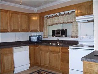 updated kitchen has oak cabinets