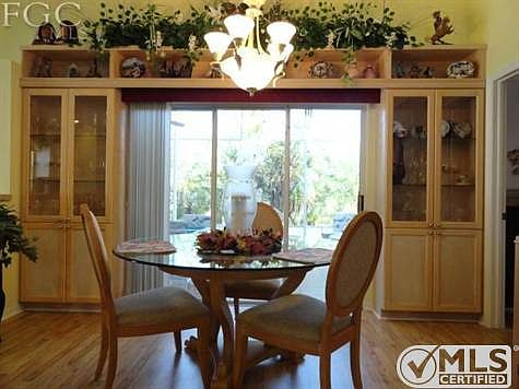Dining Room with Built-In Wood Unit Surrounding Triple Slider