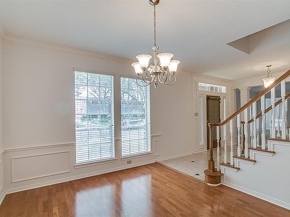 FORMAL DINING ROOM WITH RICH HARDWOOD FLOORING.