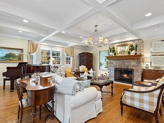 Features fireplace and coffered ceiling