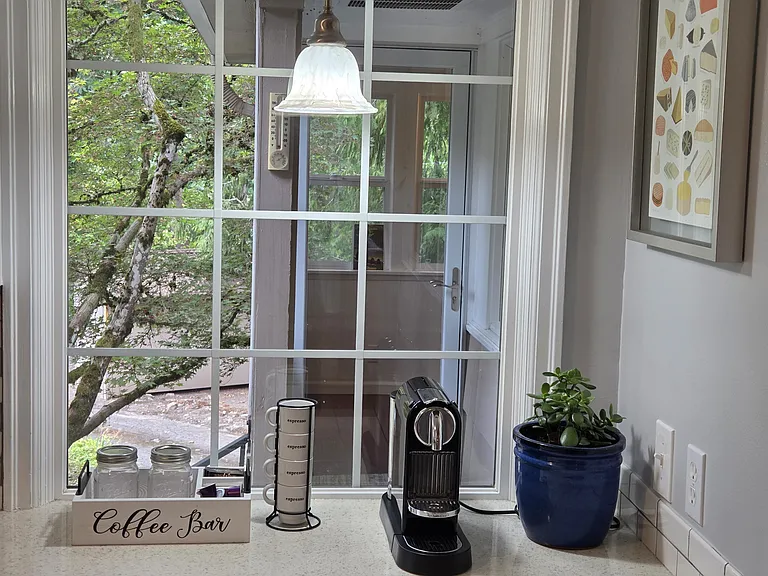 A charming coffee station offers the perfect retreat to craft a gourmet espresso or a simple, cozy cup of coffee or tea.