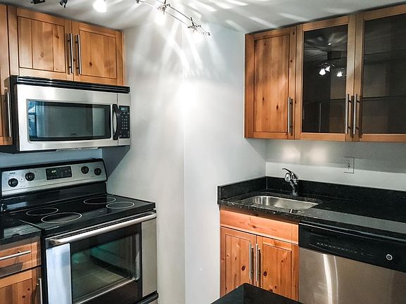 Kitchen with granite counter tops, stainless steel appliances (including dishwasher), and lots of storage not visible in photo