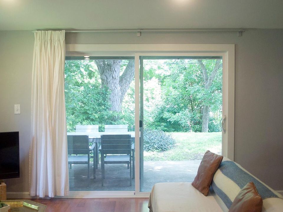 Large Glass sliding door with view to patio and backyard