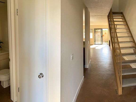 View from entry. Powder room and hall closet to the left.