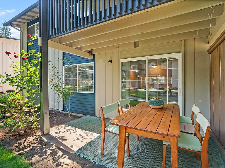 Cozy up in this charming outdoor patio, surrounded by natural beauty and style.