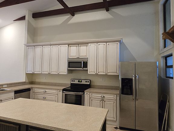 Large kitchen with white cabinets and large center island