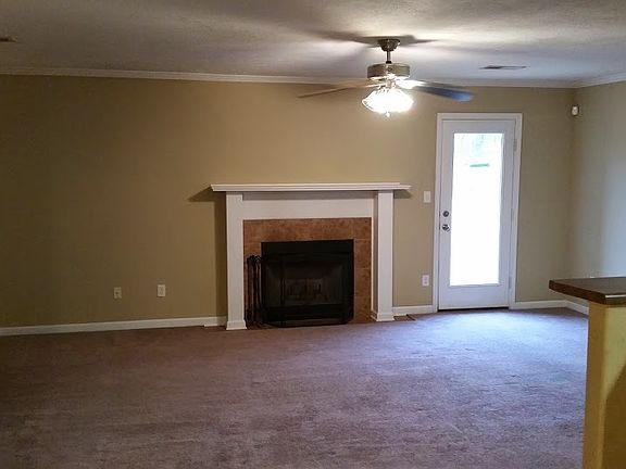 Living room with side door and fireplace