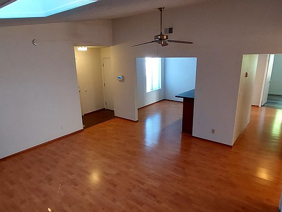 Living room (left to ride: access to garage, front door, bonus room, and hallway)