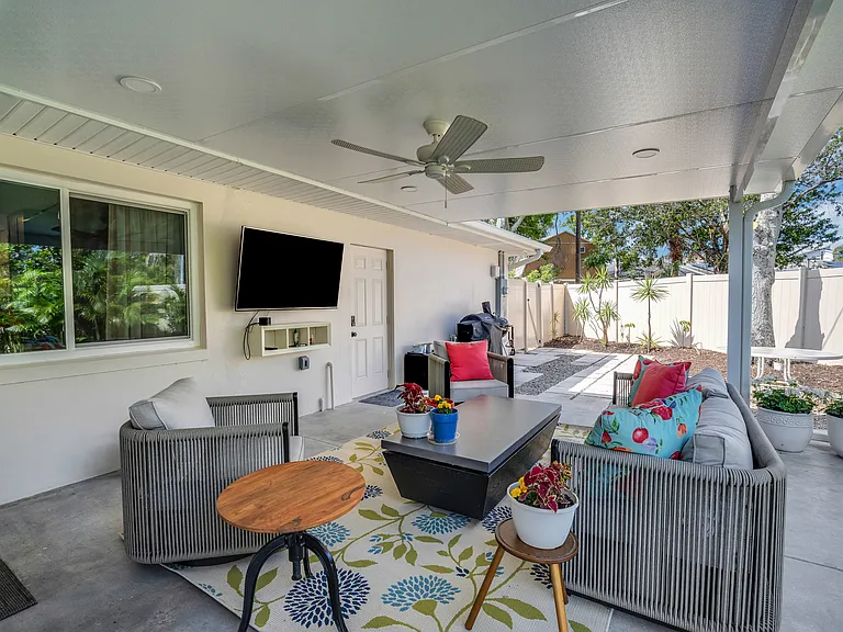 Outdoor living area with big screen TV.
