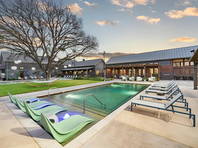 Evenings by the two pools at Modera McKinney Ridge offer a peaceful, inviting retreat with ample space to lounge and unwind.