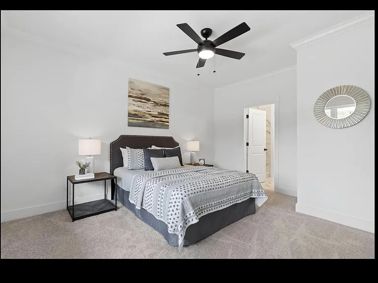 Master suite with ceiling fan.