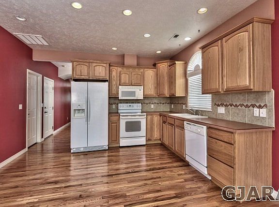 Hardwood flooring flows through much of the main level, including the kitchen, e