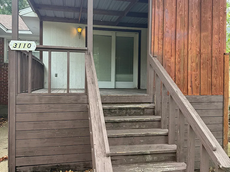 The stairs to the deck leading to the back yard.