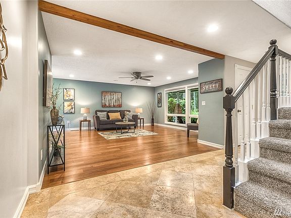 From the entry looking in the living room and the wall of windows letting in nature and light!