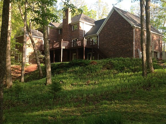 Back of home with cedar deck